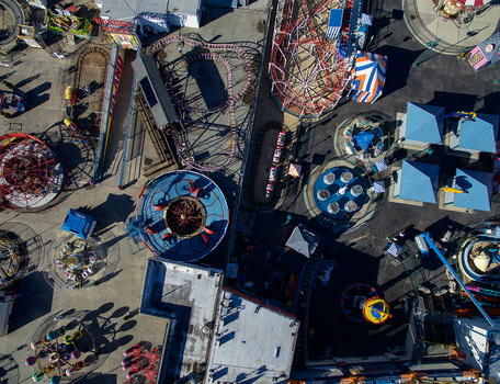Aerial view of Coney Island amusement park with various roller coasters colorful rides and structures in Kings County New York United States.