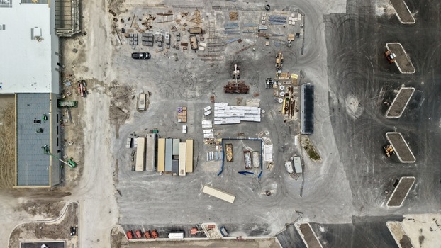 Aerial view of the Foundry Lane construction site with shipping containers building materials and heavy machinery in World Golf Village Florida United States.
