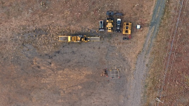 Aerial view of yellow construction machinery and heavy equipment parked on a dirt field in Golden Colorado United States.