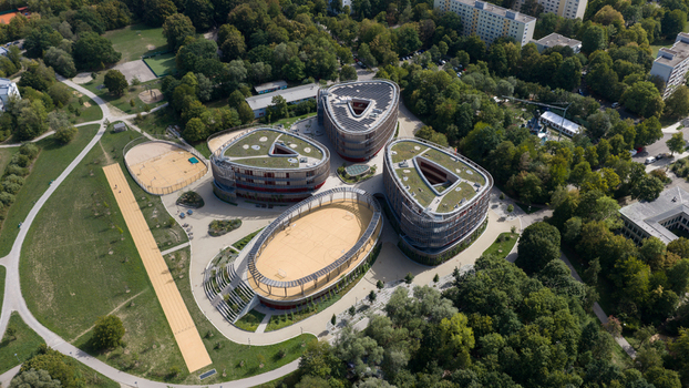 Durmersheim Germany 12 September 2026 Aerial view of the modern Wilhelm Hausenstein Gymnasium complex with triangular buildings green roofs and a central sports court.
