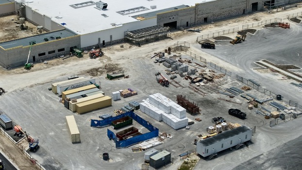 Aerial view of the Foundry Lane construction site featuring industrial buildings and shipping containers World Golf Village Florida United States.
