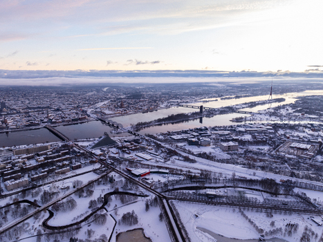 Aerial view of the cityscape of Riga covered in snow with the Daugava River and the National Library of Latvia Riga Latvia.