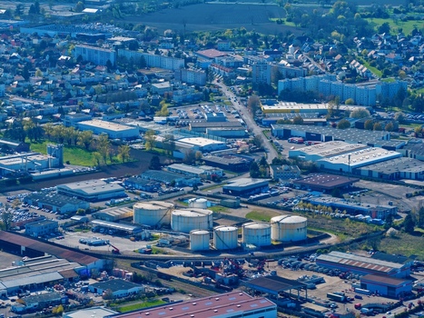 Aerial view of industrial buildings and storage tanks contrasting with residential areas a vibrant tableau from above Sausheim Grand Est France.