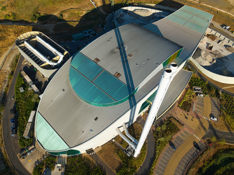 Aerial view of the Energy Recovery Facility a biomass to electricity plant with a large curved roof and tall chimneys in Bicester England United Kingdom.