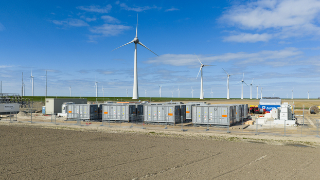 Espel Netherlands 04 April 2026 Aerial view of the Westermeerdijk wind farm with wind turbines and battery energy storage containers under a blue sky.