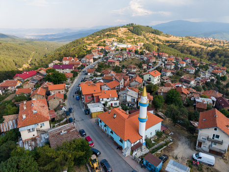 Aerial view of the village of Sveta Petka featuring a mosque with a minaret surrounded by houses with red tiled roofs in the hilly landscape of Sveta Petka Pazardzhik Bulgaria. Aerial view of the village of Sveta Petka featuring a mosque with a minaret surrounded by houses with red tiled roofs in the hilly landscape of Sveta Petka Pazardzhik Bulgaria.