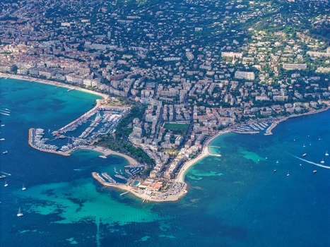 Aerial view of the coastal city of Cannes with its marinas sandy beaches and dense urban architecture along the Mediterranean Sea in Cannes Provence Alpes Cote d Azur France. Aerial view of the coastal city of Cannes with its marinas sandy beaches and dense urban architecture along the Mediterranean Sea in Cannes Provence Alpes Cote d Azur France.