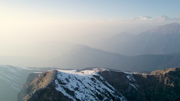 Aerial view of Shri Tungnath Temple and snowy Himalayan peaks India.