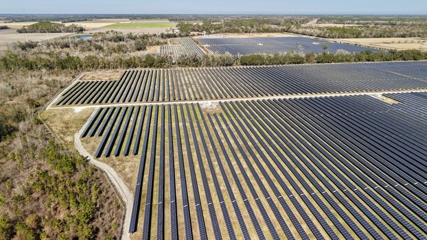 Aerial view of a vast solar farm stretching across the landscape under a clear sky Elkton Florida United States. Aerial view of a vast solar farm stretching across the landscape under a clear sky Elkton Florida United States.