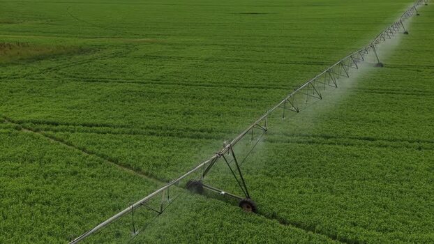 Aerial view of an irrigation system in a green field Portugal.