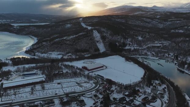 Aerial view of buildings and snow covered mountains Norway.