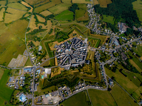 Aerial view of Fort Neuf in the star shaped town of Rocroi featuring historic fortifications radial street patterns and surrounding green fields in Rocroi Grand Est France. Aerial view of Fort Neuf in the star shaped town of Rocroi featuring historic fortifications radial street patterns and surrounding green fields in Rocroi Grand Est France.