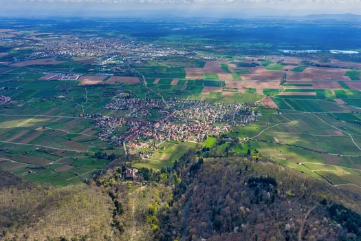 Aerial view of the Ch&acirc;teau de Kintzheim nestled amidst a sea of green vineyards and forests a tapestry of natural beauty unfolds beneath the vast sky Kintzheim Grand Est France.