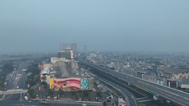 Bekasi Barat Indonesia 20 June 2026 Aerial view of Metropolitan Mall Bekasi surrounded by dense urban infrastructure a highway overpass and buildings under a hazy sky. Bekasi Barat Indonesia 20 June 2026 Aerial view of Metropolitan Mall Bekasi surrounded by dense urban infrastructure a highway overpass and buildings under a hazy sky.