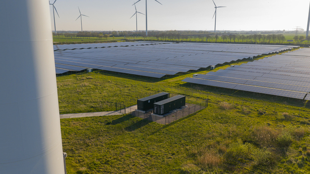 Aerial view of Solar park Delfzijl featuring rows of photovoltaic panels and wind turbines under a clear sky in Farmsum Groningen Netherlands. Aerial view of Solar park Delfzijl featuring rows of photovoltaic panels and wind turbines under a clear sky in Farmsum Groningen Netherlands.