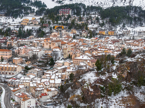 Aerial view of the historic town of Pescocostanzo with snow covered stone buildings and surrounding mountains Pescocostanzo Abruzzo Italy.