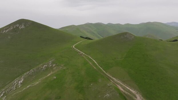 Aerial view of rolling green hills in Castelluccio Italy.