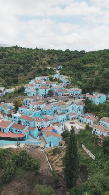 Aerial view of blue houses in the village of Juzcar Spain.