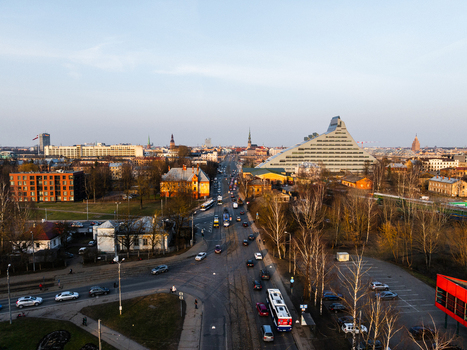 Aerial view of the National Library of Latvia and the urban landscape of Uzvaras bulvaris with traffic and the historic skyline of Old Riga in the distance Riga Latvia. Aerial view of the National Library of Latvia and the urban landscape of Uzvaras bulvaris with traffic and the historic skyline of Old Riga in the distance Riga Latvia.