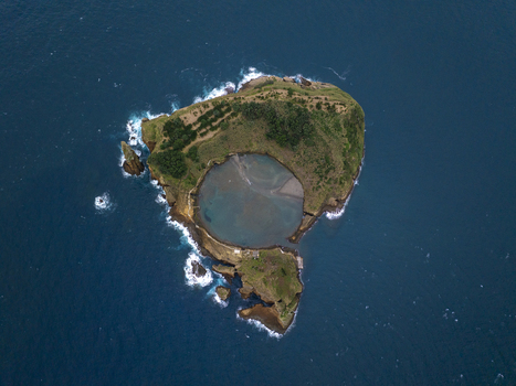 Aerial view of Ilheu de Vila Franca do Campo a volcanic islet with a circular crater lagoon surrounded by deep blue Atlantic waters lush vegetation Sao Pedro Acores Portugal. Aerial view of Ilheu de Vila Franca do Campo a volcanic islet with a circular crater lagoon surrounded by deep blue Atlantic waters lush vegetation Sao Pedro Acores Portugal.