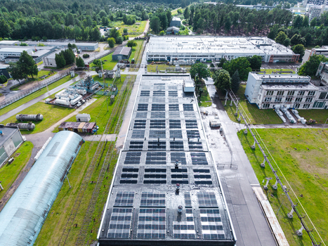 Olaine parish Latvia 04 July 2026 Aerial view of an industrial facility with a flat roof covered in solar panels surrounded by green lawns storage tanks and forest. Olaine parish Latvia 04 July 2026 Aerial view of an industrial facility with a flat roof covered in solar panels surrounded by green lawns storage tanks and forest.