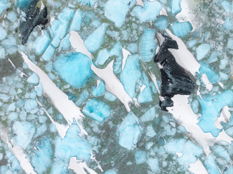 Aerial view of turquoise ice formations scattered amidst the stark white expanses and dark rocky outcrops creating a mesmerizing mosaic &Ouml;r&aelig;fi Sveitarf&eacute;lagi&eth; Hornafj&ouml;r&eth;ur Iceland.
