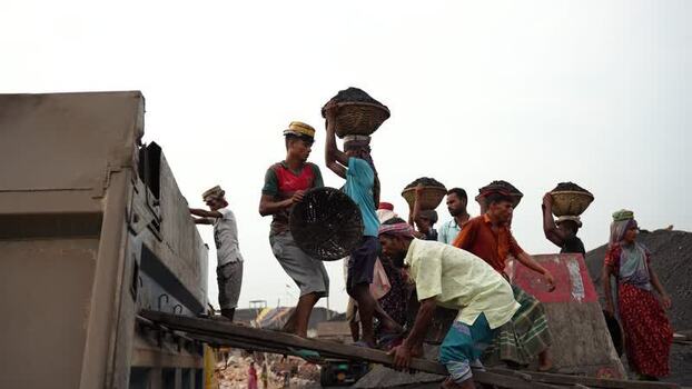 View of workers unloading coal at Aminbazar Bangladesh.