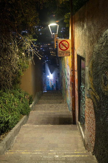 View of Guanajuato Capital staircase at night featuring colorful graffiti on stone walls illuminated by a street lamp in Guanajuato Guanajuato Mexico. View of Guanajuato Capital staircase at night featuring colorful graffiti on stone walls illuminated by a street lamp in Guanajuato Guanajuato Mexico.
