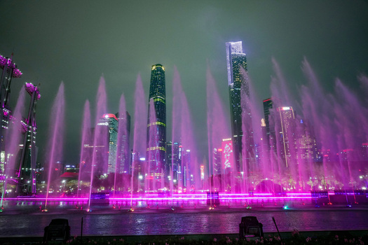 Guangzhou China 24 February 2024 View of the illuminated musical fountain show at Huacheng Square with the modern skyscrapers of the Pearl River New Town skyline at night. Guangzhou China 24 February 2024 View of the illuminated musical fountain show at Huacheng Square with the modern skyscrapers of the Pearl River New Town skyline at night.