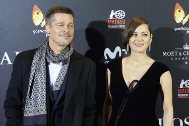 Pregnant Marion Cotillard leans in to speak to Brad Pitt as the pair promote their new film Allied in Madrid Spain