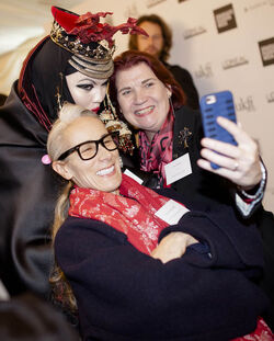 Alesha Dixon fashions a shiny turquoise jacket as she and boyfriend Azuka Ononye support Graduate Fashion Week London