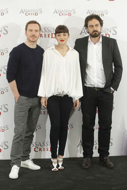Pregnant Marion Cotillard covers her bump in a loose white Area shirt as she poses with Michael Fassbender at the Assasin s Creed Photocall Madrid