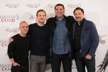 Pregnant Marion Cotillard covers her bump in a loose white Area shirt as she poses with Michael Fassbender at the Assasin s Creed Photocall Madrid