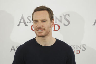 Pregnant Marion Cotillard covers her bump in a loose white Area shirt as she poses with Michael Fassbender at the Assasin s Creed Photocall Madrid