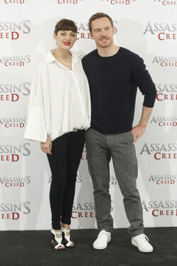 Pregnant Marion Cotillard covers her bump in a loose white Area shirt as she poses with Michael Fassbender at the Assasin s Creed Photocall Madrid