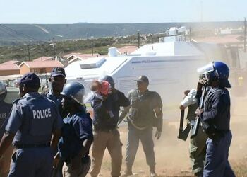Heart stopping moment South African dad throws his own toddler off roof in protest at illegal shack being demolished Heart stopping moment South African dad throws his own toddler off roof in protest at illegal shack being demolished