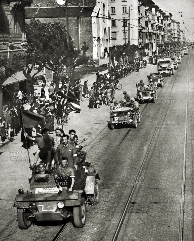 SECONDA GUERRA MONDIALE Piemonte: le truppe americane precedute da una staffetta di partigiani garibaldini attraversano un centro abitato liberato durante l\