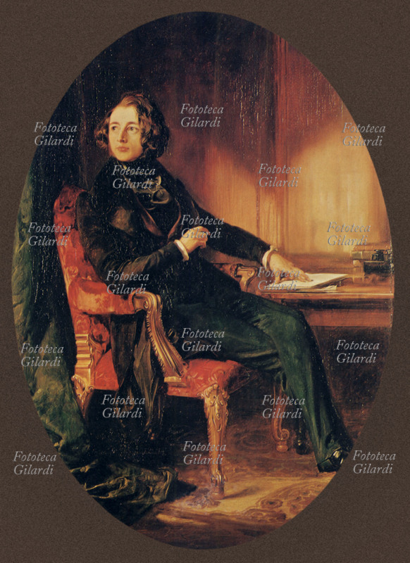 Charles DICKENS (1812-1870) ritratto alla scrivania in occasione della conclusione del romanzo \