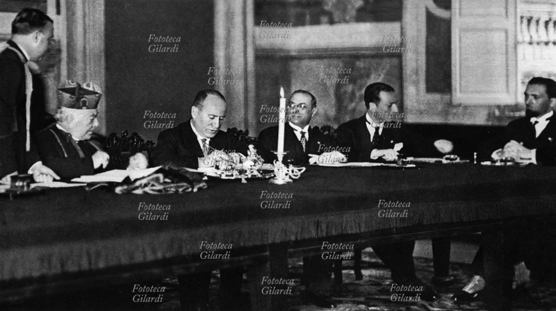 ROMAN QUESTION Cardinal Secretary of State Pietro Gasparri (5 May 1852 – 18 November 1934) and Benito Mussolini (29 July 1883 – 28 April 1945) signed the Lateran Pacts, composed of a treaty, a convention and a concordat (subsequently submitted to approval of the Italian Parliament and became operational on the following 7 June). The ceremony took place in the Palace of San Giovanni in Laterano, and definitively closed the almost sixty-year-old conflict between the Kingdom of Italy and the Holy See, which obtained recognition as an independent state under the spiritual and temporal government of Pope, who thus regained freedom of action with respect to the unknown brought about by the advent of fascism, while on the other hand Mussolini intended to exploit the reconciliation so as not to have obstacles in bringing the large audience of Catholics to the fascist movement. Rome, 11 February 1929.