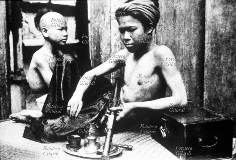 INDOCINA FRANCESE Fumatori di oppio si preparano la pipa. Tonchino, 1900.