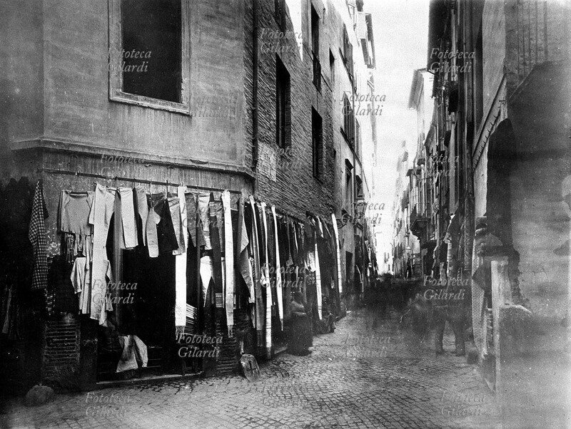 ROME view of the Jewish ghetto, Via Rua. A shop displays long scarves, an element of traditional Orthodox clothing. Photography, Rome 1900.