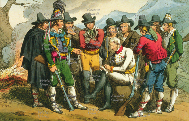 BRIGANTI Scena di vita di una banda di briganti: sono tutti riuniti intorno a un ufficiale, che potrebbe essere un loro ostaggio ma anche il loro comandante. Ci furono casi, infatti, in cui in Re Borbone incaricò un ufficiale di guidare i briganti contro l\