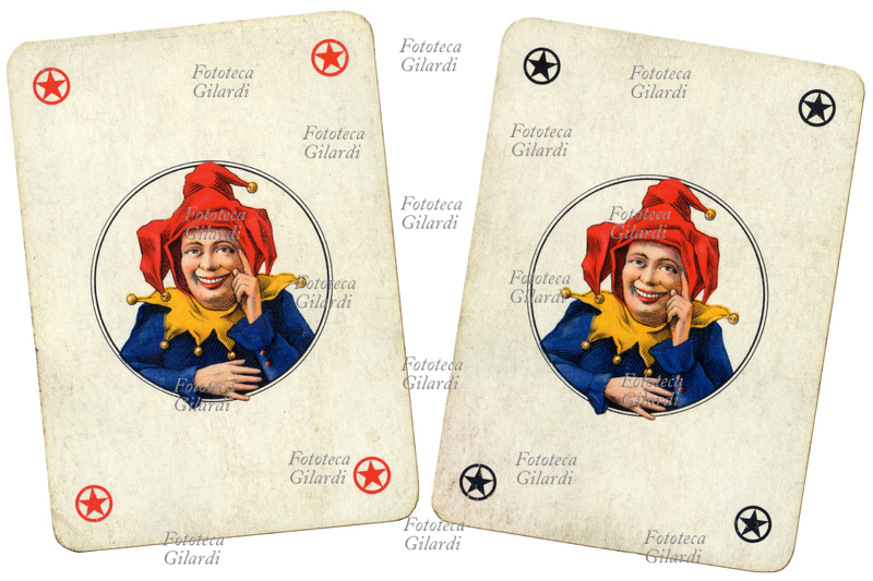 PLAYING CARDS: Jolly Joker, the fool, depicted as a smiling jester wearing a three-cornered hat with bells, pointing upward. Rummy playing cards. Black Joker and red Joker (white background). Italy, 20th century.