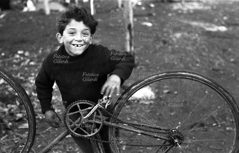 BAMBINI bambino allegro ripara una bicicletta. E\