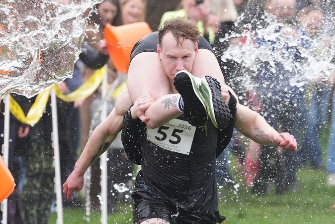 Uk l annuale gara Wife Carrying Race la corsa in cui uomini e donne devono trasportare una moglie sulle spalle Uk l annuale gara Wife Carrying Race la corsa in cui uomini e donne devono trasportare una moglie sulle spalle