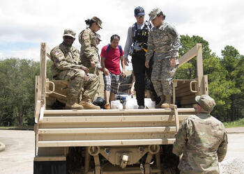 August 30, 2017 - Sugarland, Texas, United States: The Texas Military Department's 36th Sustainment Brigade, comprised of multiple Army National Guardsmen, prepare to unload local residents to safety during water rescue operations, due to devastating effects caused by Hurricane Harvey's aftermath. Harvey made landfall into the Texas coast last week as a category 4 hurricane. (Polaris)