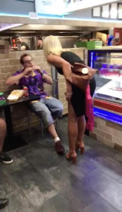 PIC FROM MERCURY PRESS (PICTURED: THE BLONDE WOMAN REMONSTRATES WITH LEWIS CALEY IN A TAKE AWAY IN CLACTON-ON-SEA IN ESSEX) This is the moment a foul-mouthed blonde lady launched herself at a drunken reveller in a shocking takeaway brawl - because he suggested she was in her 60s and threw a chip in her face. Lewis Caley and his friends were getting food from the Quality Diner takeaway in Clacton-on-Sea, Essex, after celebrating his 20th birthday. However an argument ensued when cocky Lewis asked one of the women - estimated to be in her 30s - how old she was and then jokingly suggested she was in her 60s. Footage shows the blonde brand jolly engineer Lewis a c**t and then repeatedly try to snatch his food from him as he sits eating. SEE MERCURY COPY