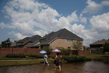 September 2, 2017 - Fort Bend County, Texas, United States: Local residents cross a flooded street in the Millwood subdivision of Fort Bend County. (Marcus Yam / Los Angeles Times/Polaris)