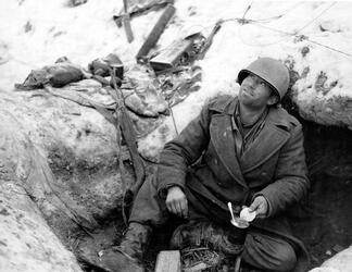 THE STORY of an unsung unit of Second Word War soldiers who stood alongside the infamous ‘Band of Brothers’ as they often fought to the last man to repel Hitler’s last big offensive has been released in a new book detailing their previously little reported struggle. Images show how this unknown band of brothers dug into fox holes in the middle of the snowy Ardennes forest as they wait for the German army to advance, while others see troops stood over the bodies of their fallen comrades. In another picture, a soldier can be seen aiming his rifle at a group of German prisoners, moving them on as they walk with their hands over their heads. The images are from the new book The 110th Holds in the Ardennes by Walter S. Zapotoczny Jr, which tells the tale of how the 110th infantry 28th division held a line through the formidable Ardennes forest against the might of Hitler’s army / Fonthill Media / mediadrumworld.com