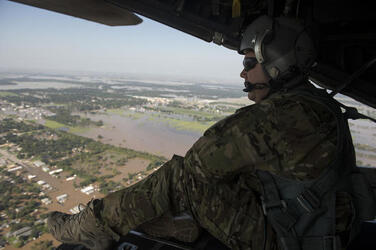 August 31, 2017 - Texas, United States: U.S. Air Force Master Sgt. Eric Valdez a loadmaster with the 129th Rescue Wing, Moffett Field, California Air National Guard, scans for hurricane survivors while flying a mission in support of Hurricane Harvey relief efforts 31 Aug, 2017 near Houston, Texas. Hurricane Harvey formed in the Gulf of Mexico and made landfall in southeastern Texas, bringing record flooding and destruction to the region. U.S. military assets supported FEMA as well as state and local authorities in rescue and relief efforts. (Jason Robertson/USAF/Polaris)